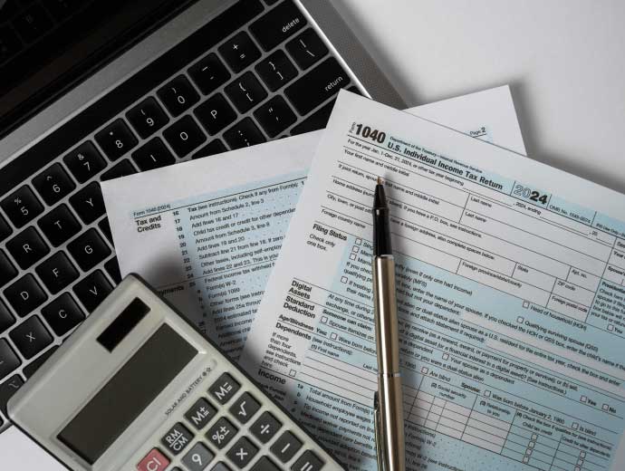Tax documents and calculator on desk