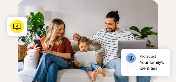 Family sitting on a couch and using multiple different devices