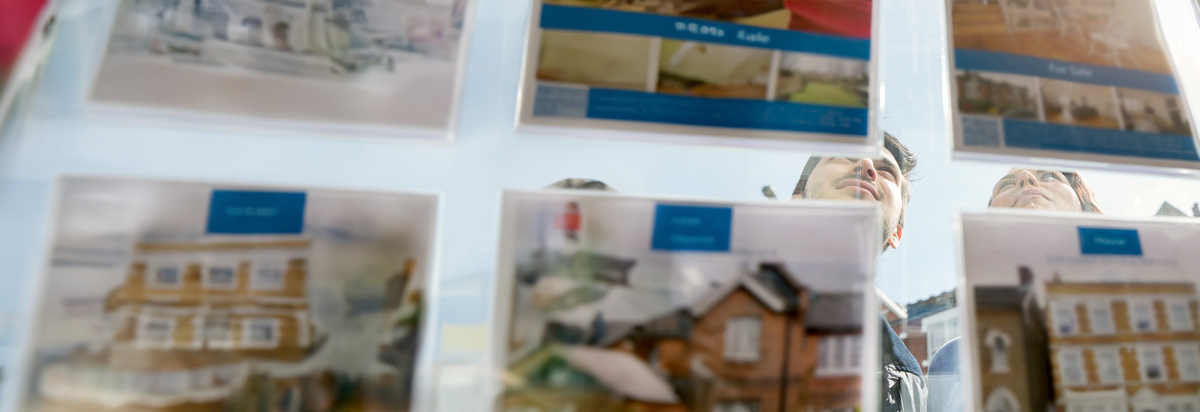 A young couple browsing real estate listings and looking out for possible real estate scams.