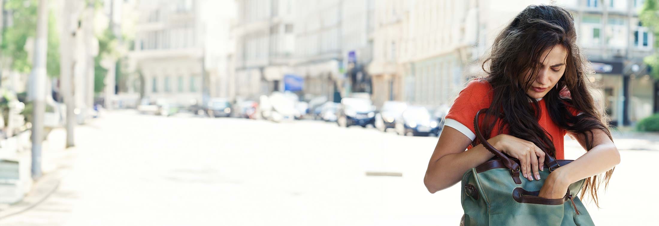 A woman searching in her bag for her lost wallet