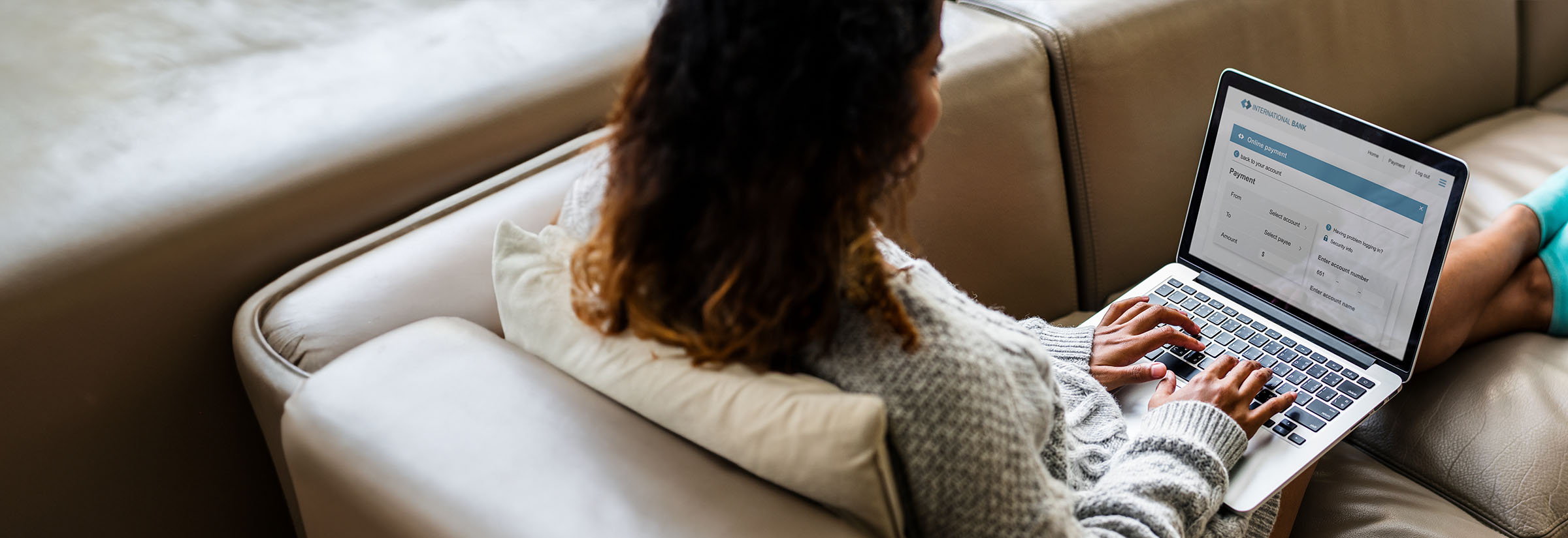 A woman sending a wire transfer from a laptop.