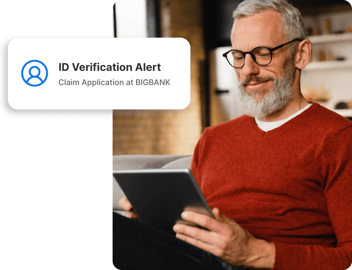  A man reviews a possible identity theft alert from LifeLock.