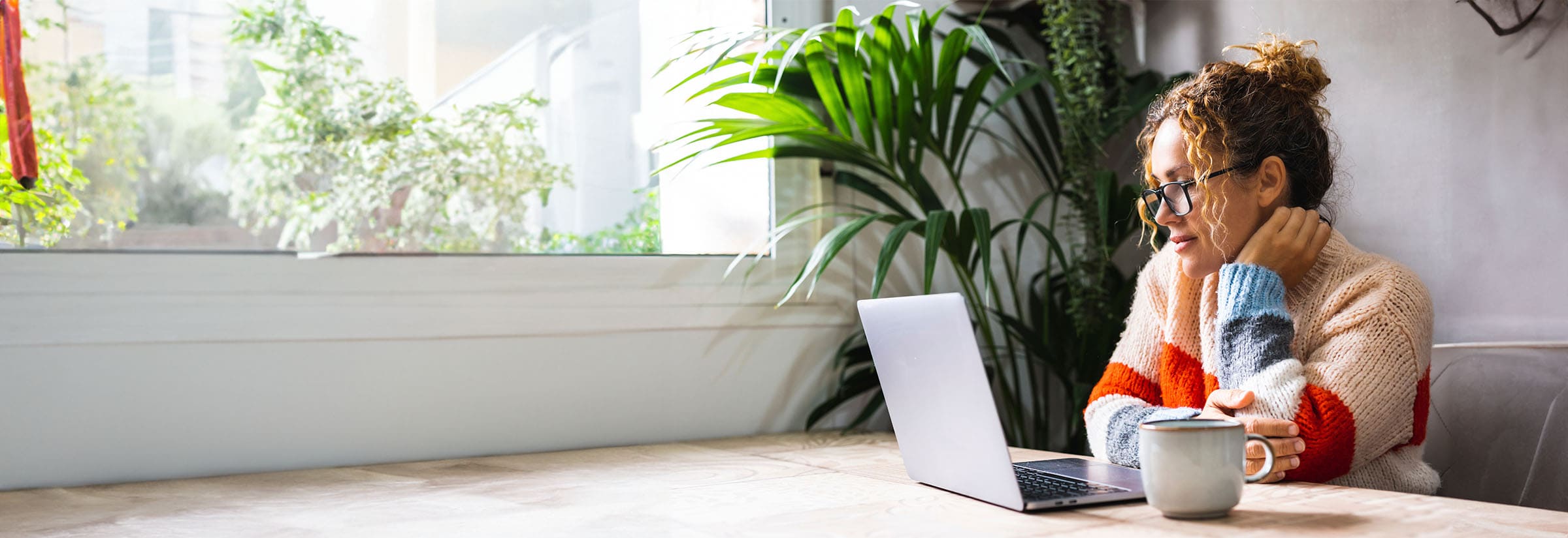 Worried woman looking at her computer, concerned about the Equifax data breach that has affected millions of consumers.