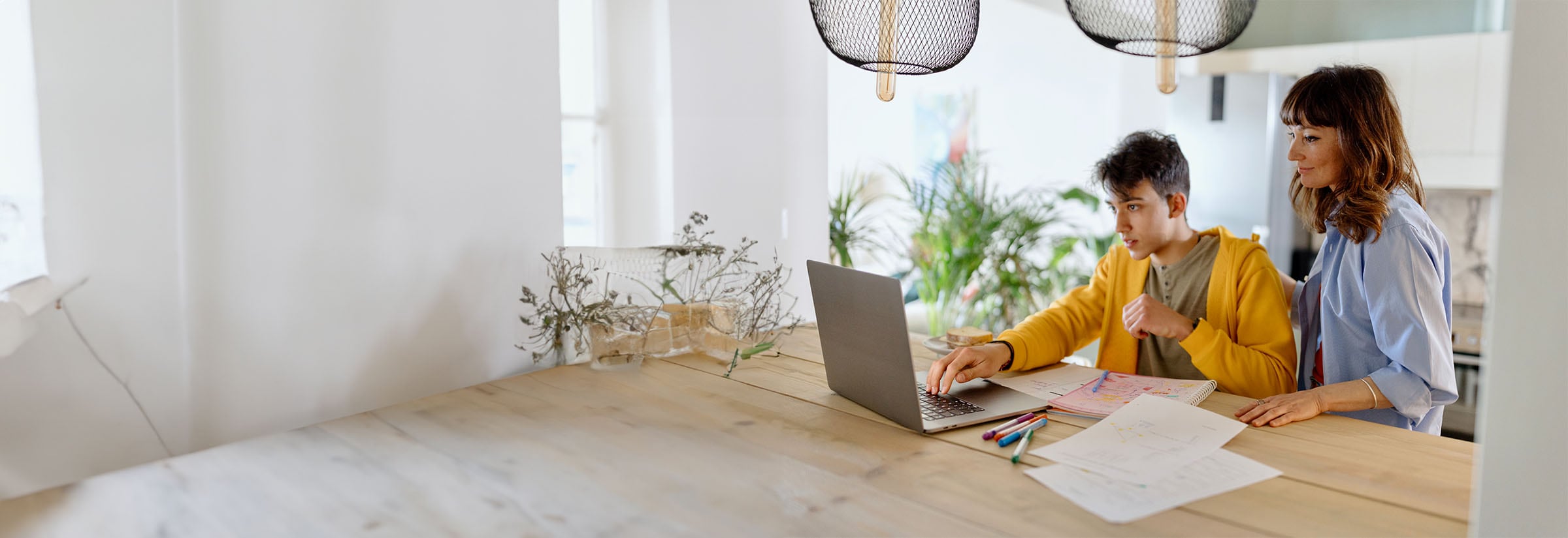 Image of a woman sitting at a coffee table with paperwork