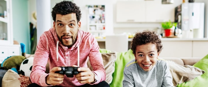 Father and son safely playing games online.