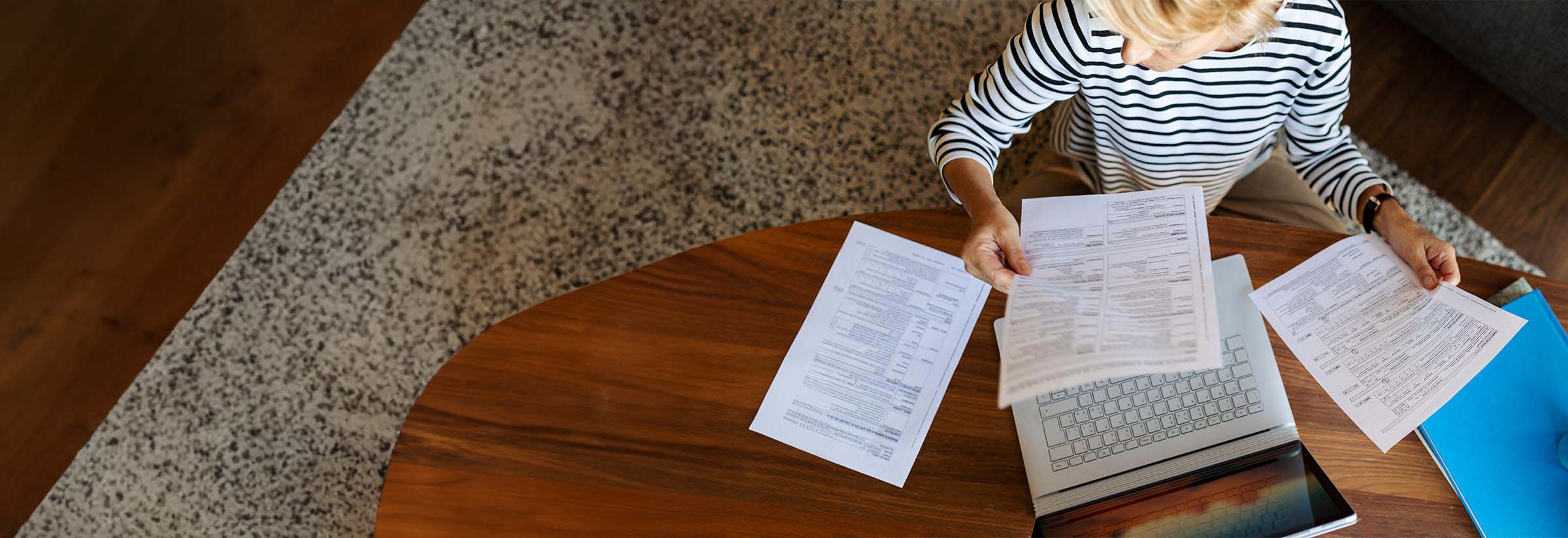 A woman holding a receipt at a desk