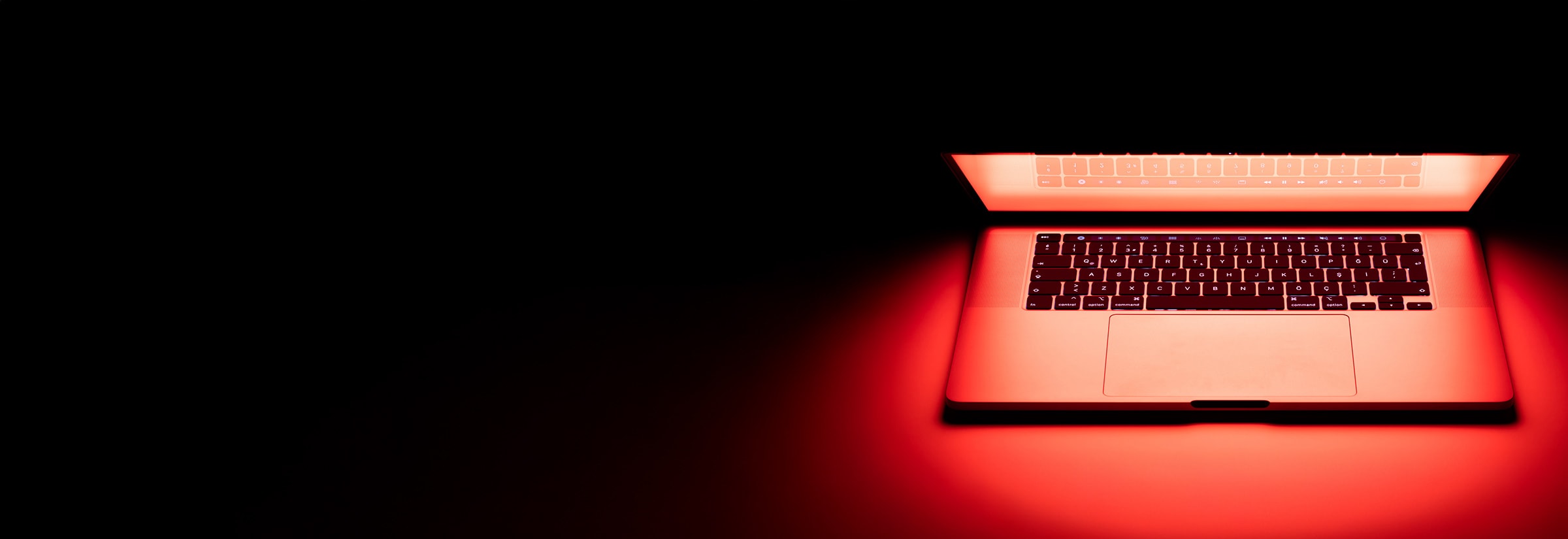 A hacked computer emitting red light.