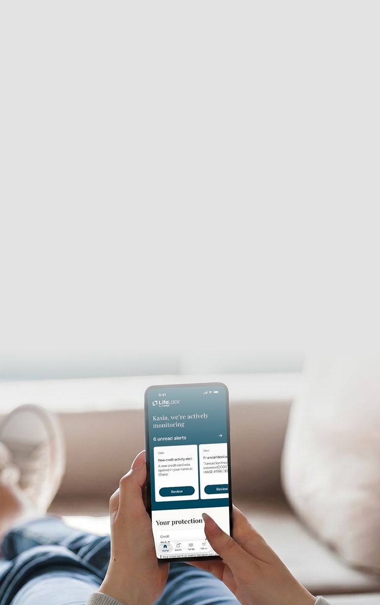 A woman checks an identity theft alert in the LifeLock app. 