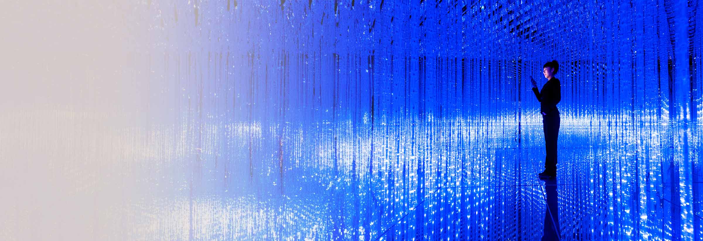 A person in an abstract field of light representing cyberspace, wondering if Aura is worth it.