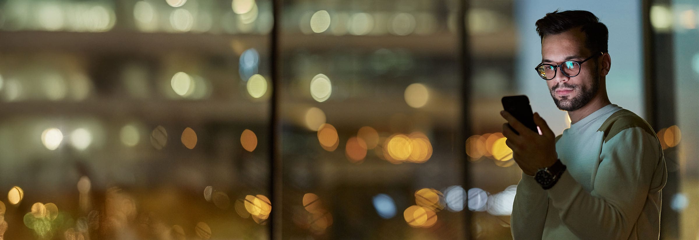 A man on his smartphone searching how to find out if his information is on the dark web.