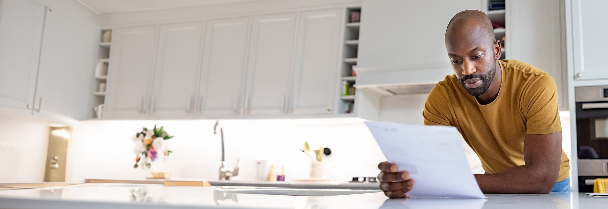 An image of a man checking his credit report after learning about synthetic identity theft.