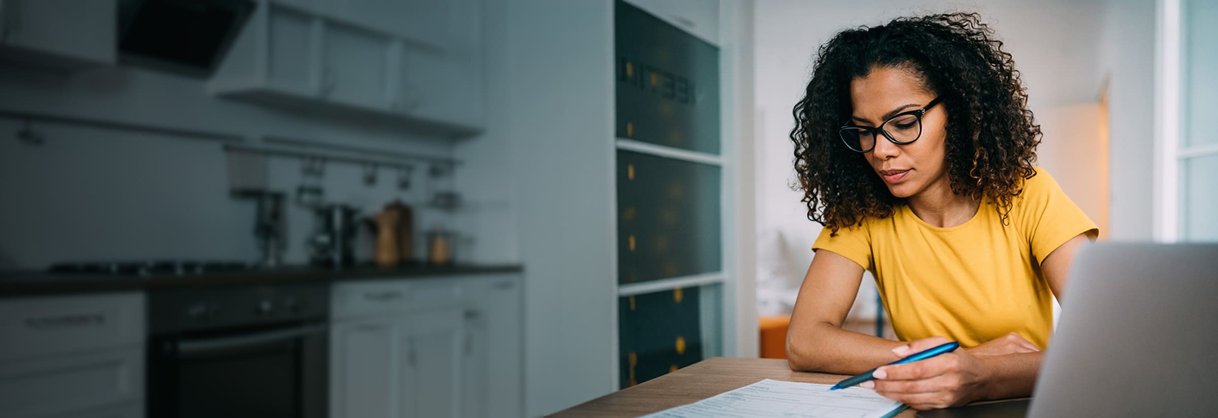 A person fills out their tax return early to avoid potential tax fraud.