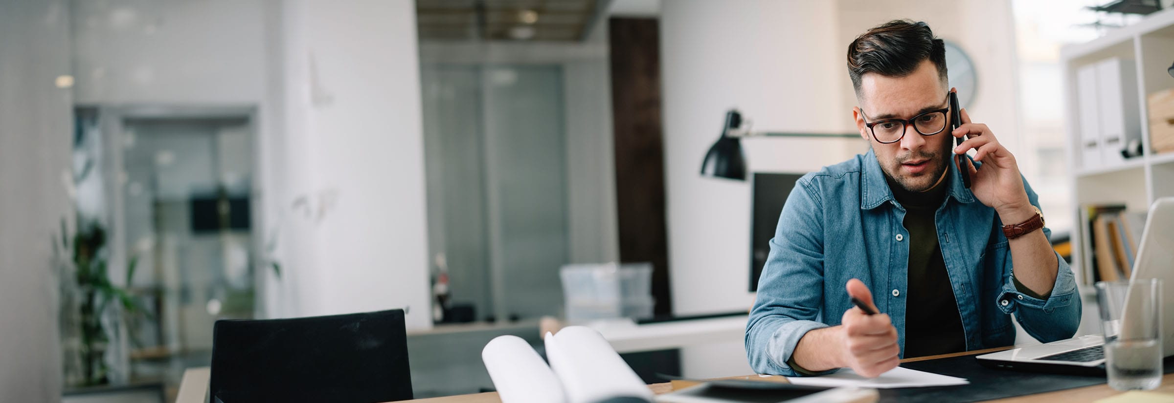 A man on the phone trying to resolve issues after being scammed.