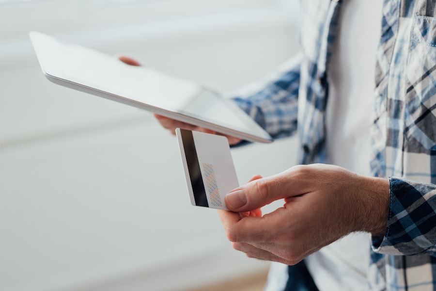 Man holding tablet and credit card