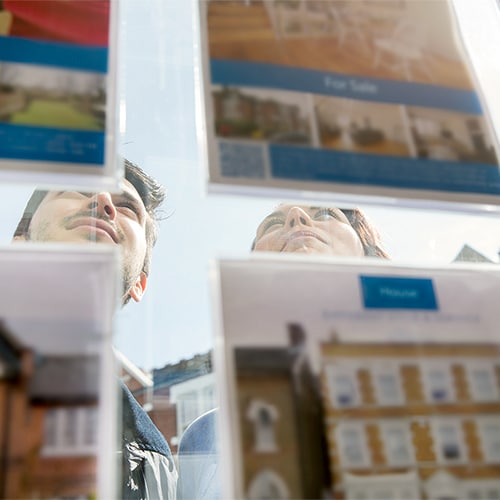 A young couple browsing real estate listings and looking out for possible real estate scams.