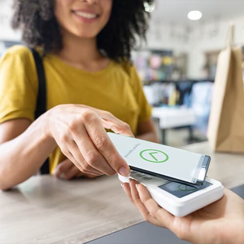 A person using the tap payment system on a mobile device.