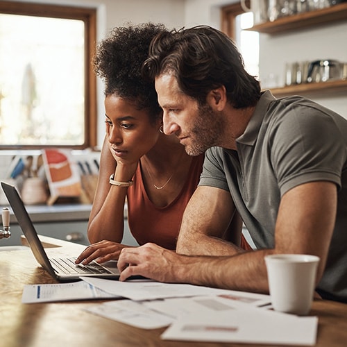 A couple sitting at a café table look at a phone and try to determine if they were affected by the latest data breach.