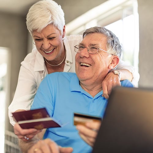 An elderly couple confidently using their passport and credit card information.