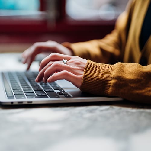 A person typing on a laptop