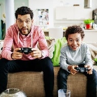 Father and son safely playing games online.