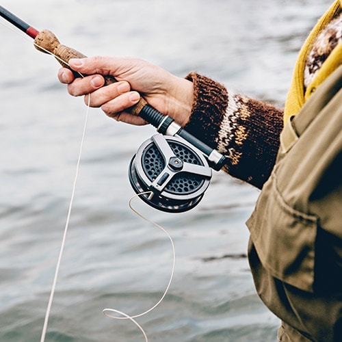 A person fishing, symbolizing phishing as a way hackers get passwords.