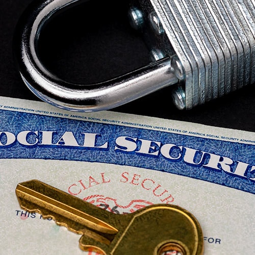 A photo of a social security card protected under lock and key.