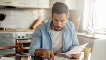 Man reviewing paperwork at table