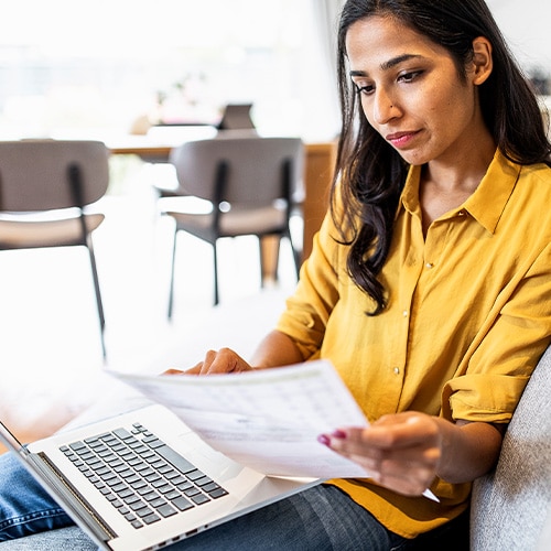 A woman receives papers that show signs of loan fraud.