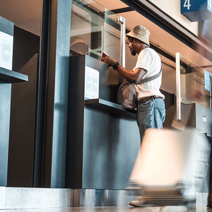 Person checking into their flight at the airport, potentially showing their REAL ID.