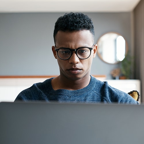 A person using a laptop to remove themselves from data broker sites.