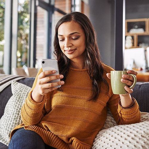 Image of a woman on her cellphone using the Telegram app.