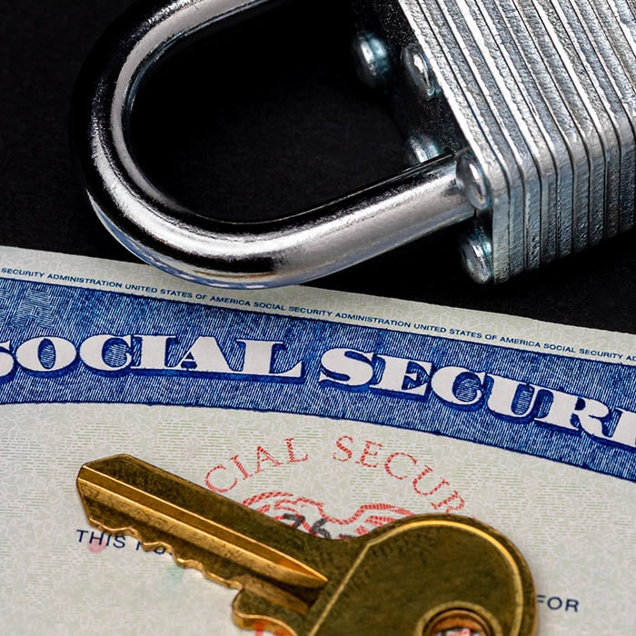 A photo of a social security card protected under lock and key.