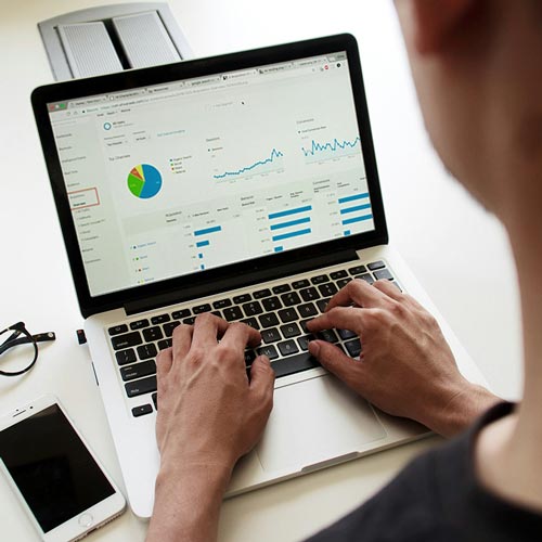 A woman on a computer researching what affects her credit score.