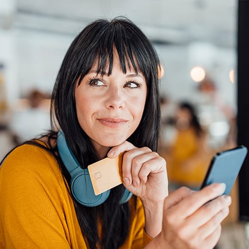 A woman using her mobile phone to lock her credit with the three credit bureaus.