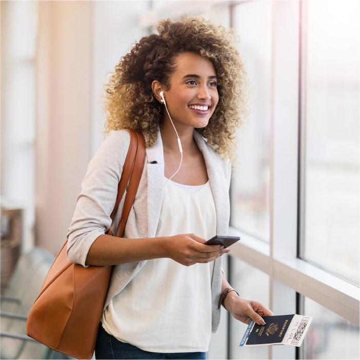 A woman holds her passport book which contains personally identifiable information (PII).