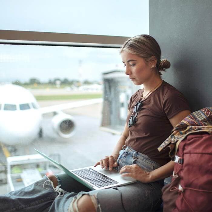 An image showing a woman reporting a lost passport at the airport.