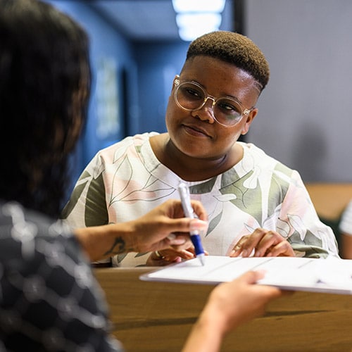 A young person consulting a post-data breach checklist after their personal information was compromised.